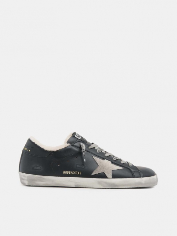 Super-Star golden goose sneakers in black leather with shearling